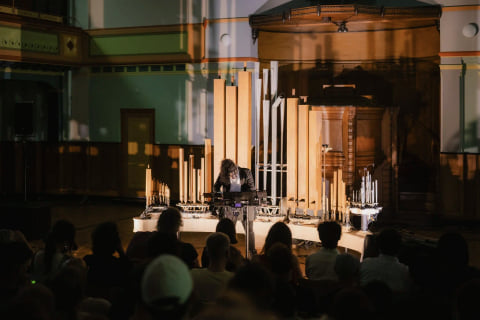 Navid Navab at the controls in the middle of the instrument, seen from behind the audience.